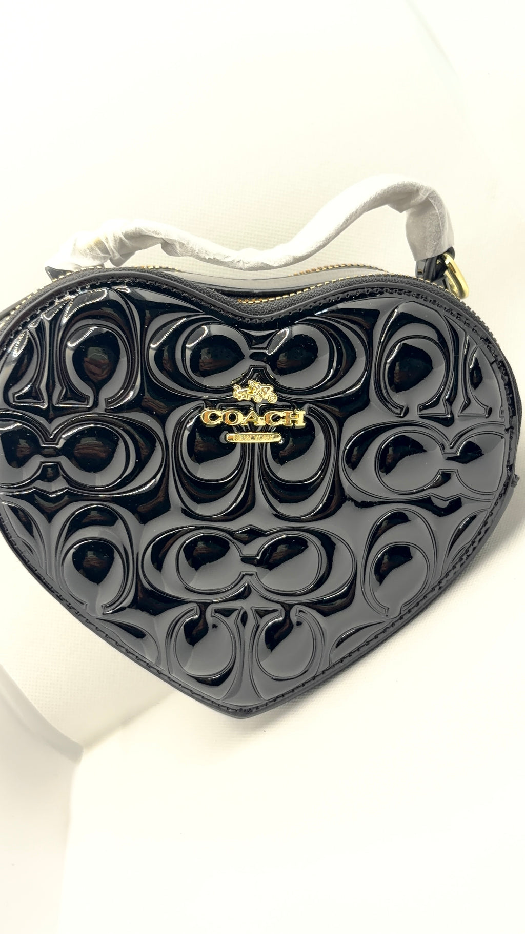 Coach heart bag black patent leather flat lay