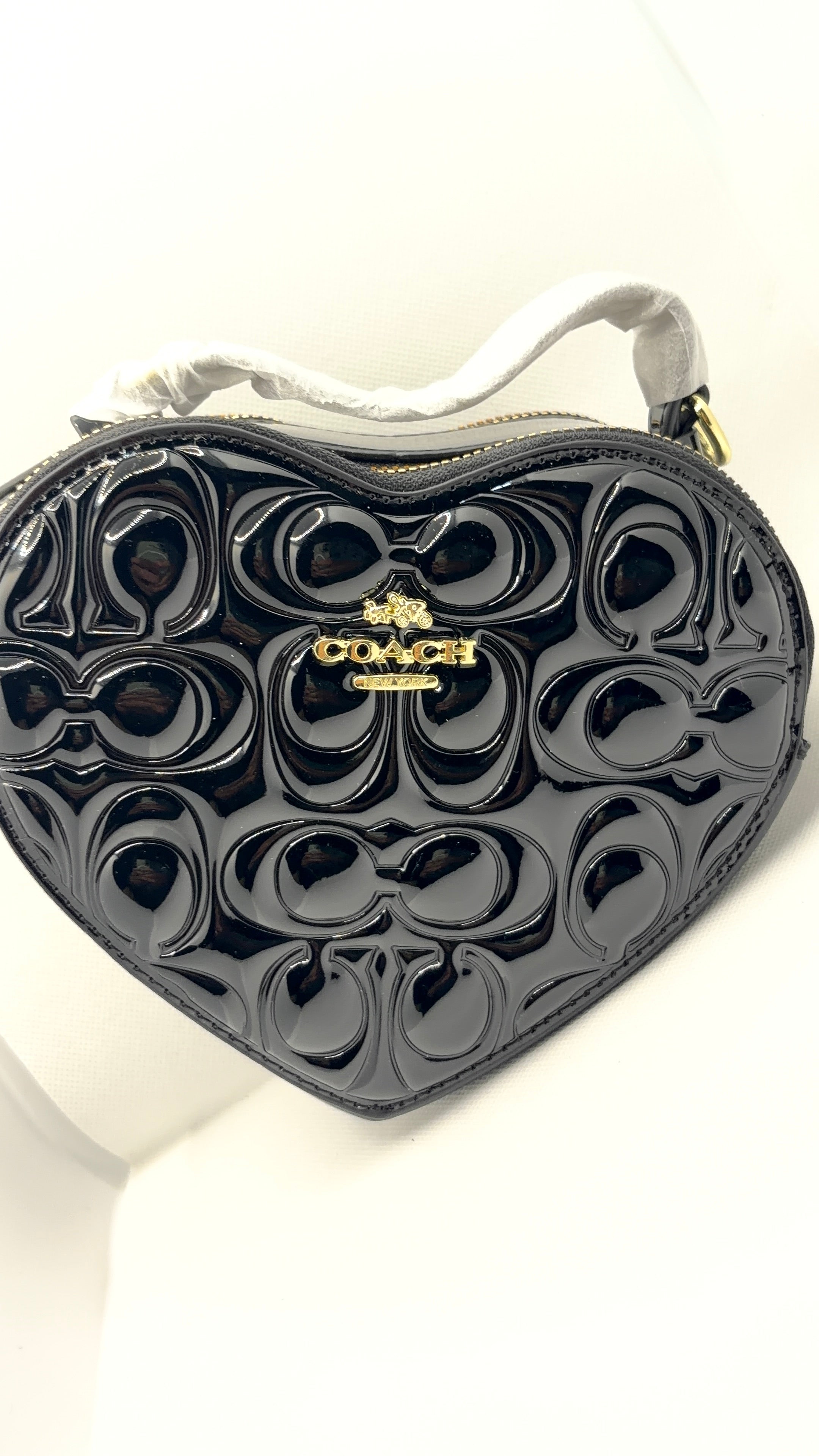 Coach heart bag black patent leather flat lay